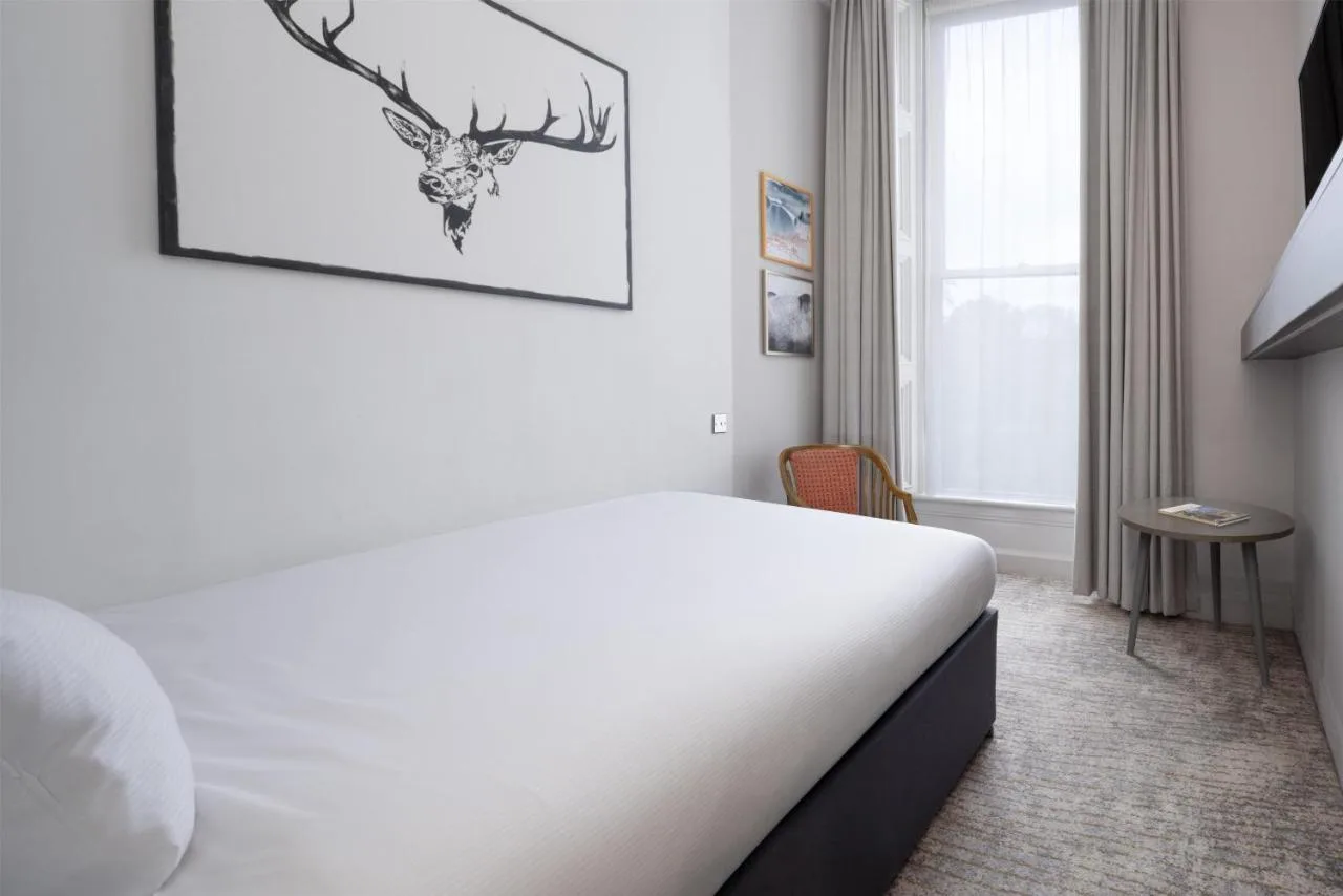 a bedroom with a bed with a deer on the wall at JA The Bruntsfield - Edinburgh in Edinburgh