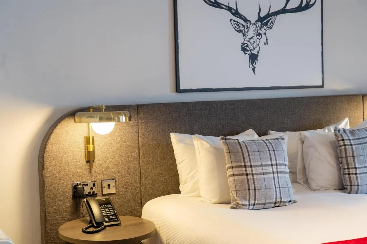 a hotel room with a bed with a phone on it at JA The Bruntsfield - Edinburgh in Edinburgh