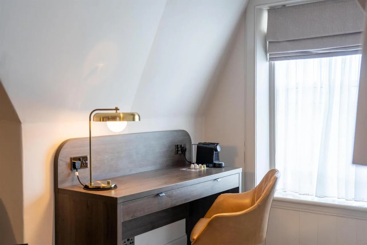 a desk in a room with a chair and a window at JA The Bruntsfield - Edinburgh in Edinburgh